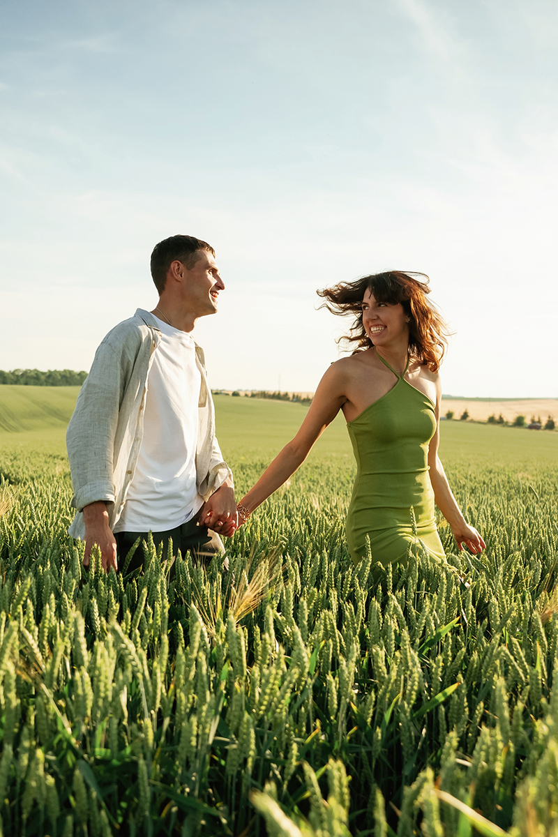 Having fun. Lovely couple are on the agricultural field together.