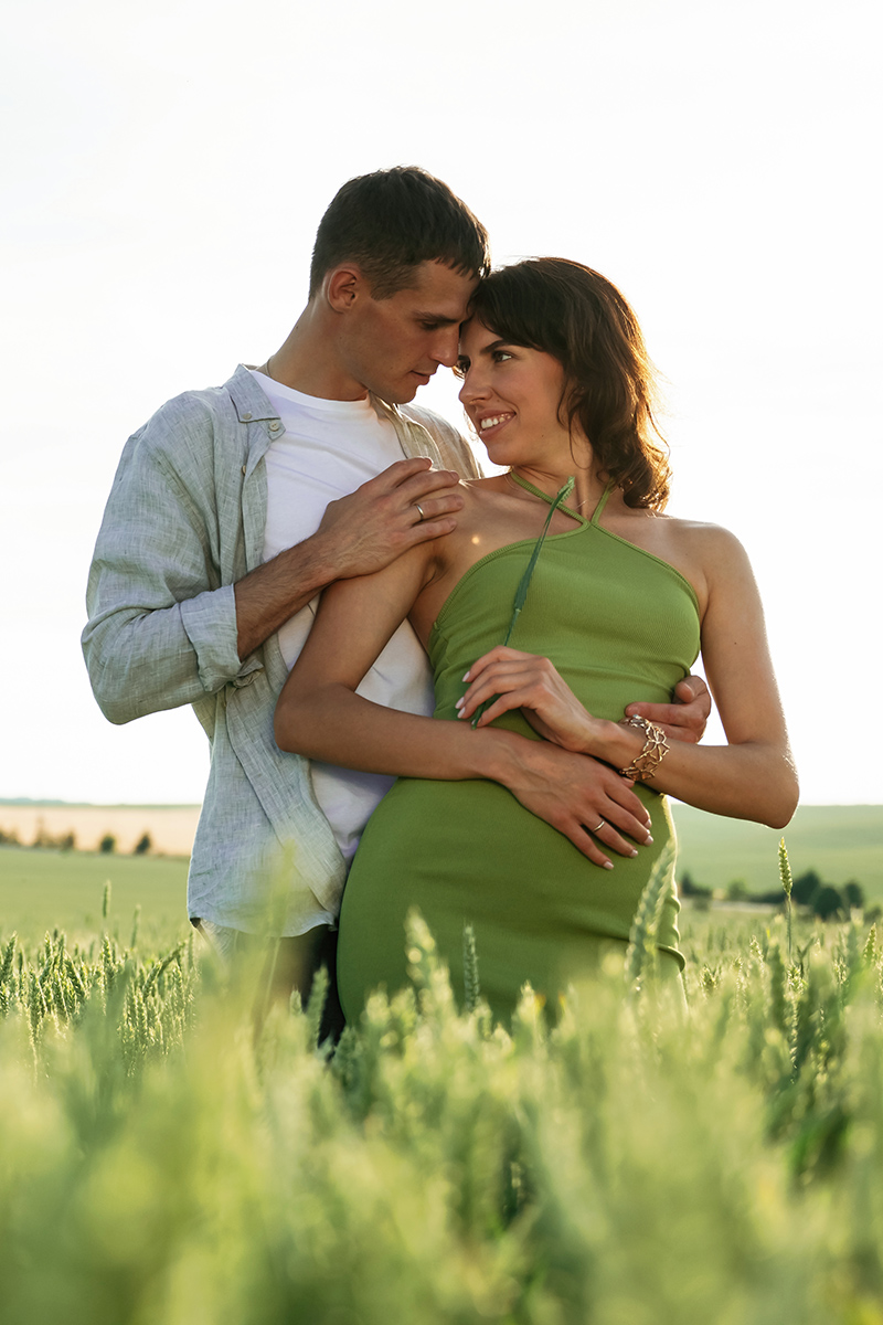 Standing and enjoying nature and each other. Lovely couple are on the agricultural field together.