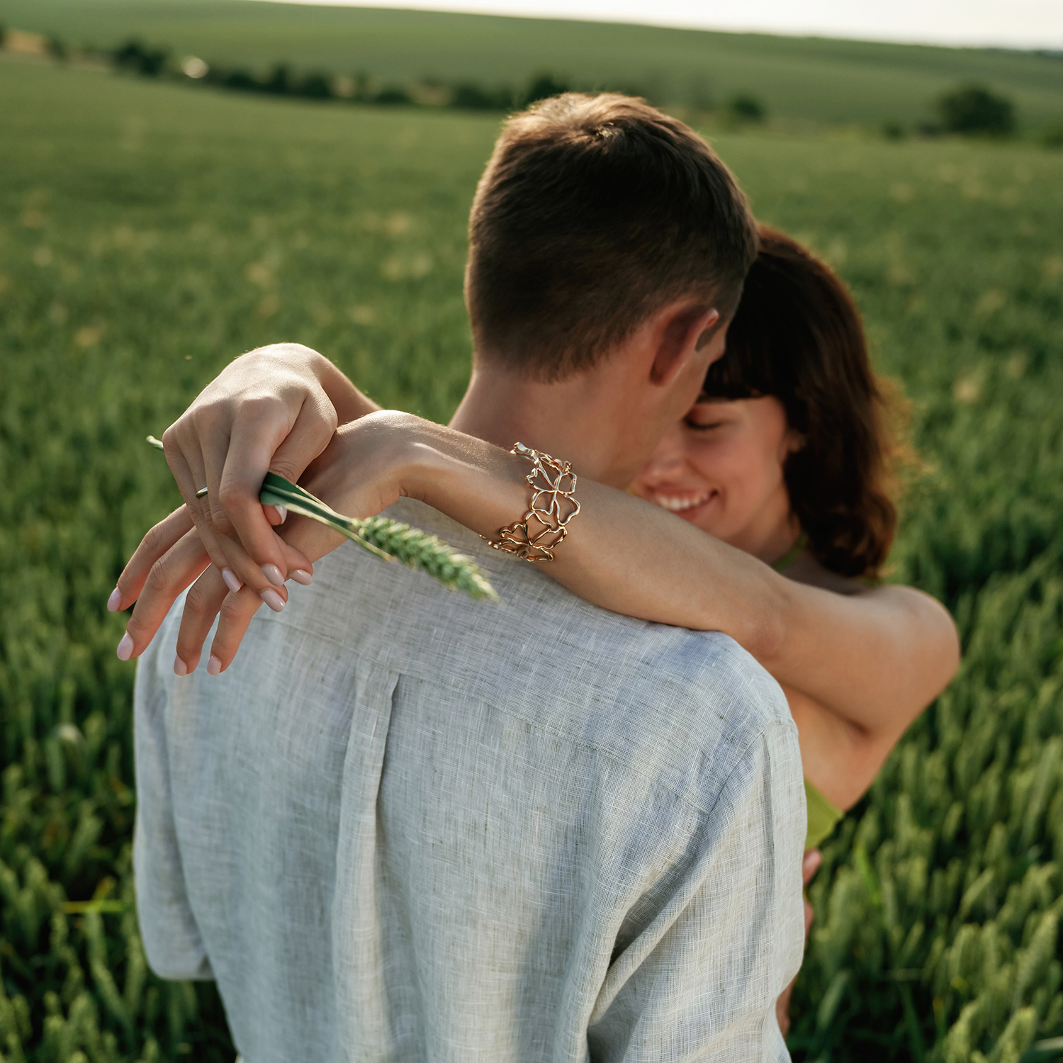 Closeness of the people, embracing. Lovely couple are on the agricultural field together.